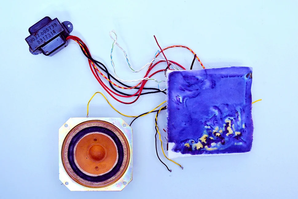 The electro colour process - featuring a circuit board covered in fabric that has been exposed, revealing yellow and blue patterns and multi-coloured wires.
