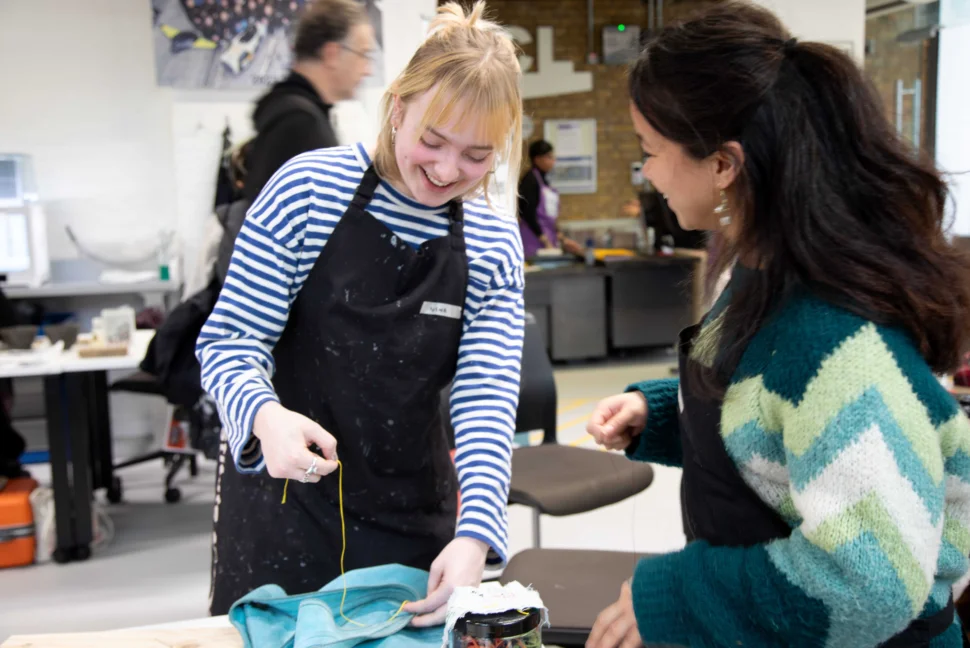 Events and Communications Interns Nina and Tia helping to mend a broken bag at the February 2026 Repair Cafe.