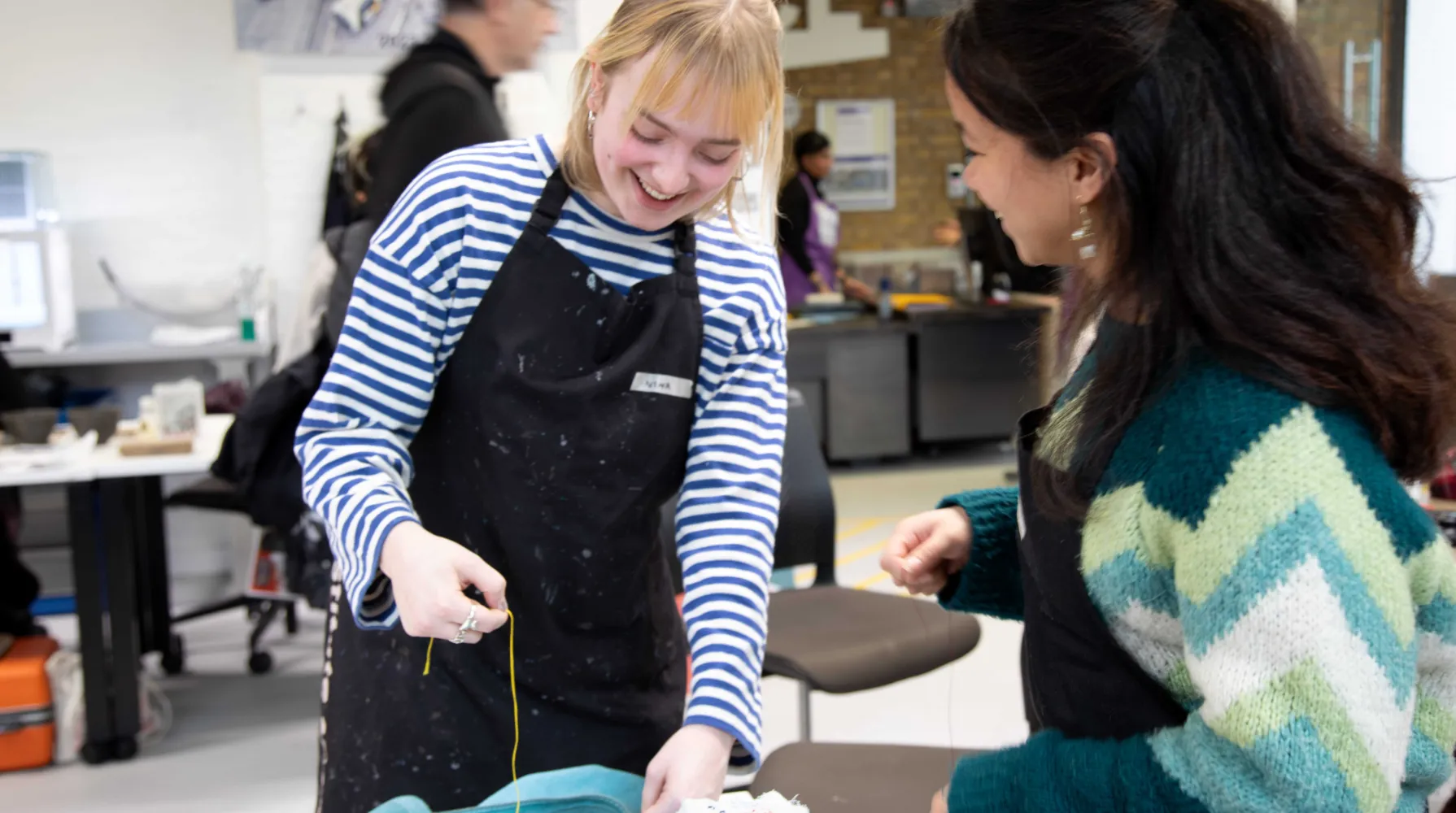 Events and Communications Interns Nina and Tia helping to mend a broken bag at the February 2026 Repair Cafe.