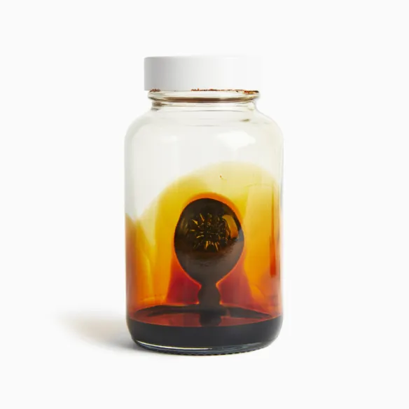 Glass jar with ferrofluid liquid and viscous blob