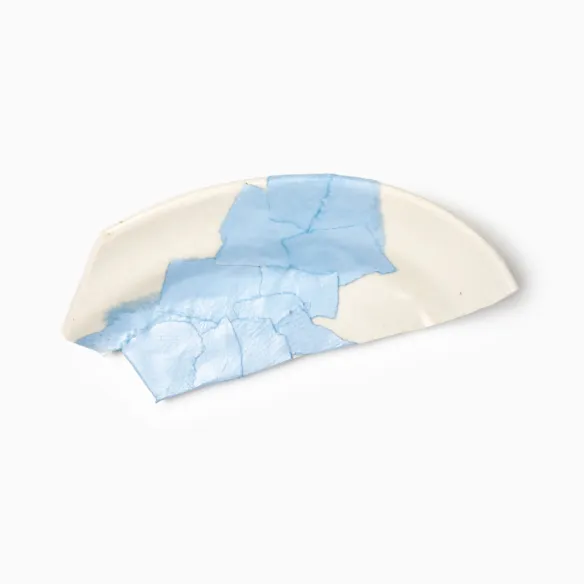 Broken ceramic fragments mended with glue and pieces of blue paper