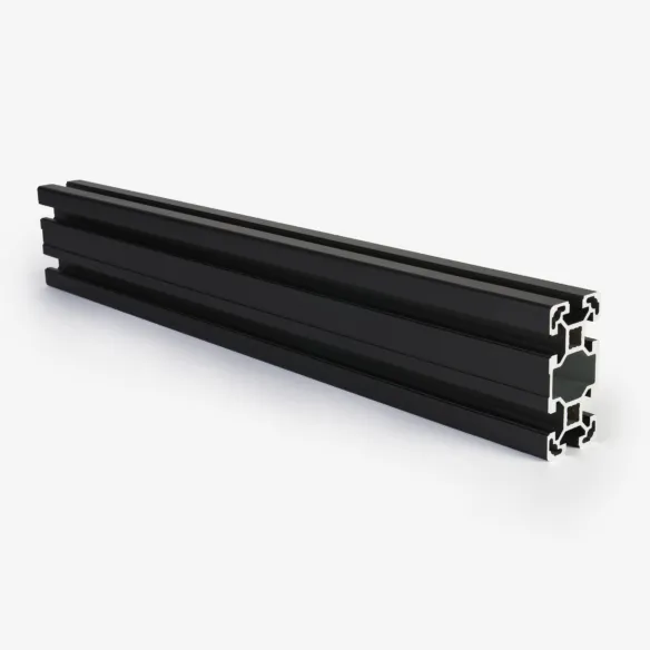 A black anodised aluminium profile is sitting on a white background with a soft shadow to ground it. It is a rectangular shaped tube and standing up on the shorter edge. There are two ridges that run along the lengths. It has an intricate profile which allows it to be easily slotted in to place. The end of the profile is a shiny textured metal.